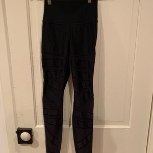 Lululemon black leggings with sheer panels.
